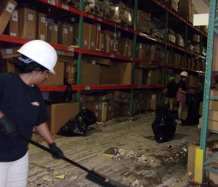 Team members in action during a warehouse cleanup.