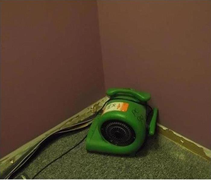 Air mover blowing on a wall