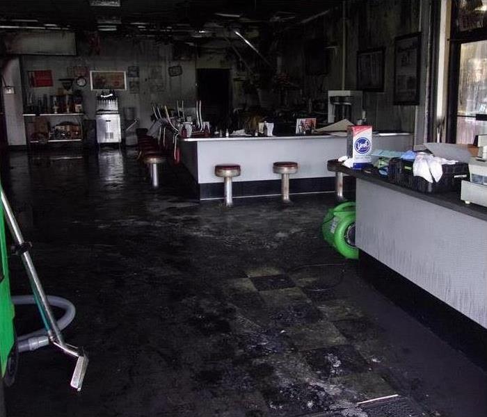 Dark diner, floor with soot damage, fire damage in a diner